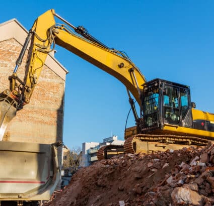 A bulldozer digging through a pile of rubble